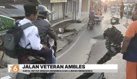 Badan Jalan Veteran di kawasan Sungai Gardu, Banjarmasin Timur, ambles pada Rabu dini hari. Enam bangunan terdampak dan arus lalu lintas terganggu.